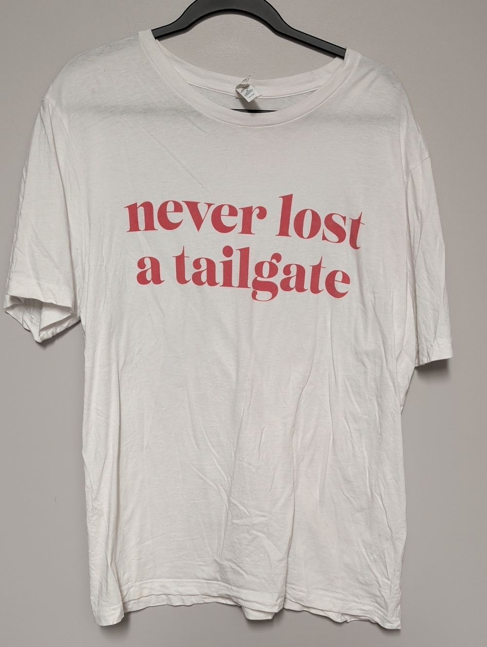 Bella Canvas White Short-Sleeve Tee with Red 'never lost a tailgate' Text